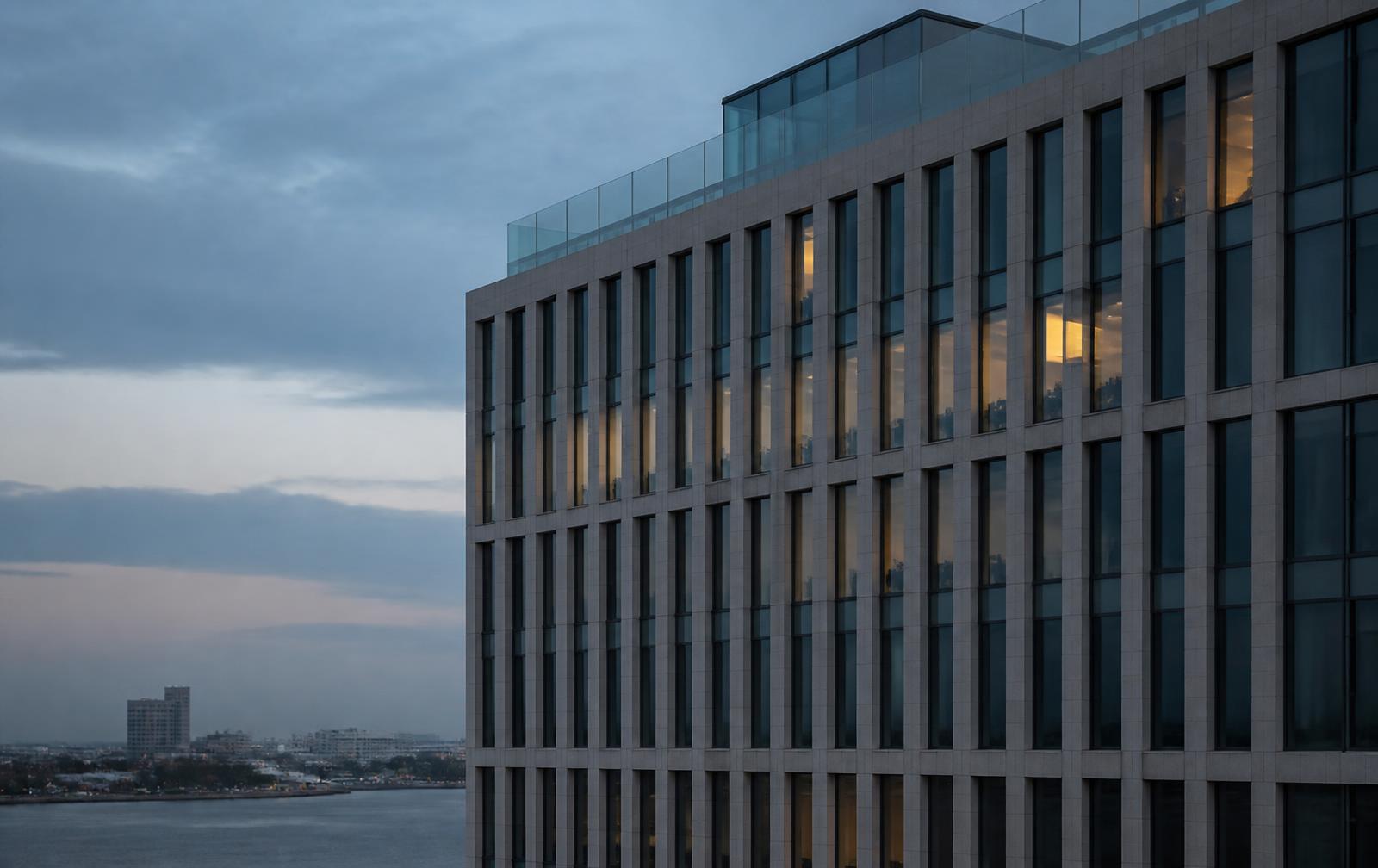 Grid facade of a modern office building at dusk